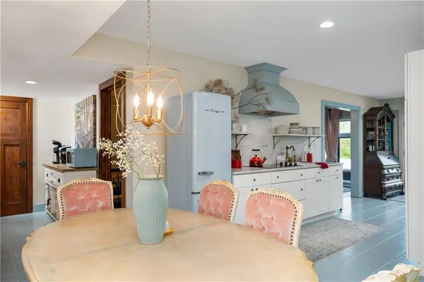 a kitchen with a refrigerator and ceiling fan