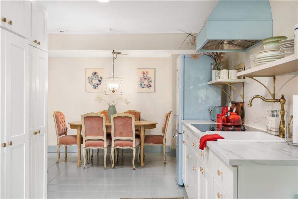311 Derry Ridge Road Ligonier, PA 15658 - Photo 34 of 42 a kitchen with a dining table chairs and white cabinets