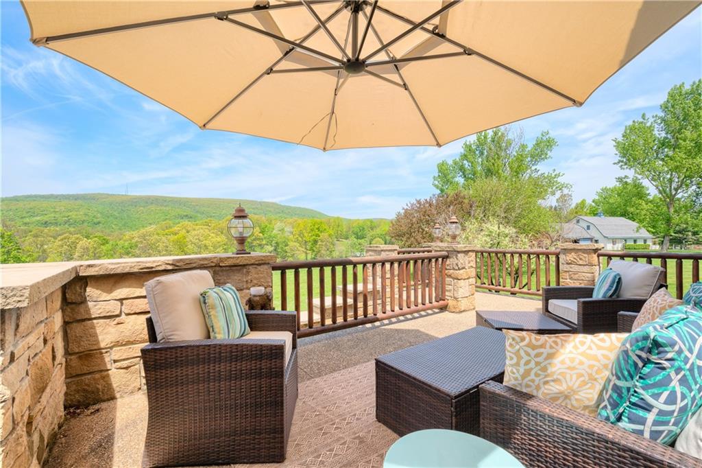 311 Derry Ridge Road Ligonier, PA 15658 - Photo 36 of 42 a view of a balcony with chairs and a umbrella