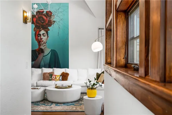 a living room with furniture and floor to ceiling window