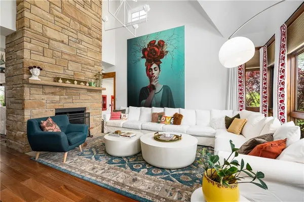 a living room with furniture a fireplace and wall paintings