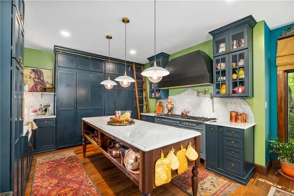 a kitchen with stainless steel appliances granite countertop a sink and a stove