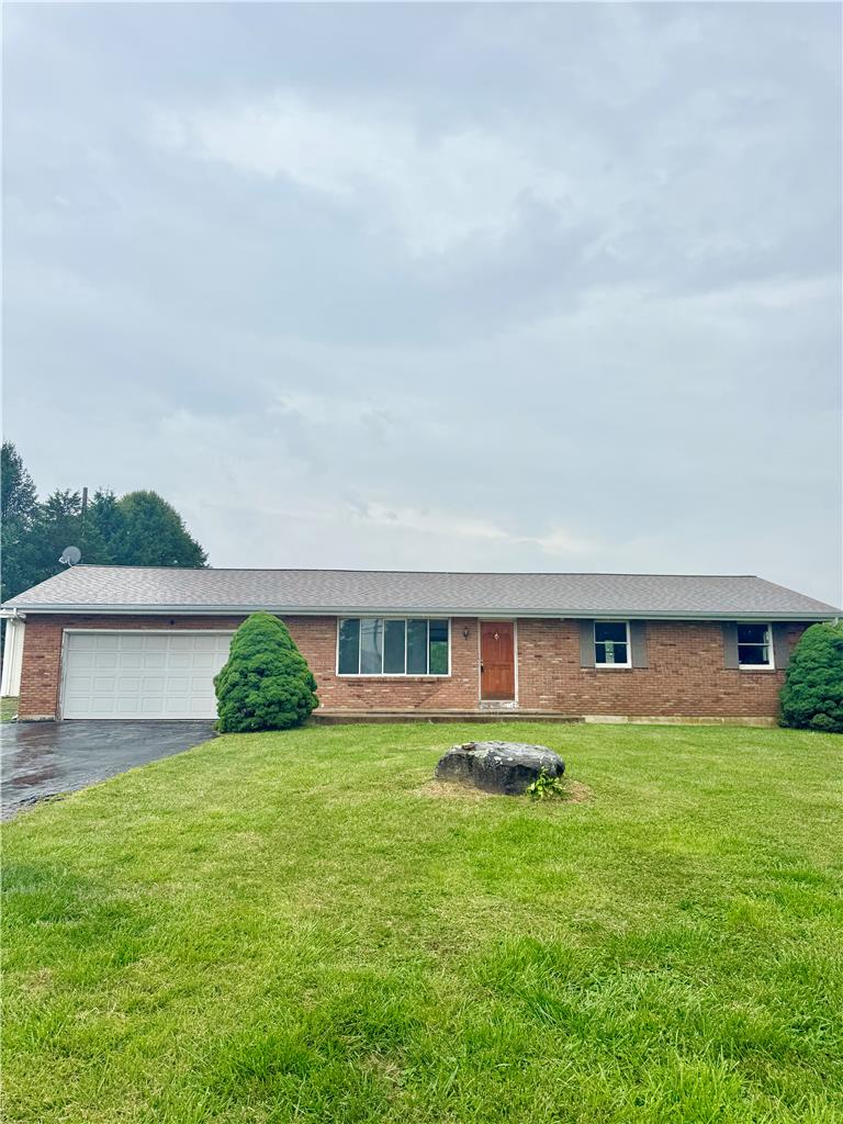 8325 Schantz Road Breinigsville, PA 18031 - Photo 1 of 21 A well-maintained ranch home with a spacious front yard, brick facade, and attached garage.