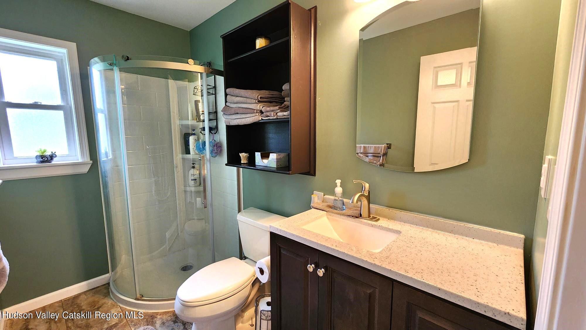 1262 County Road 2 Olivebridge, NY 12461 - Photo 13 of 42 a bathroom with a sink a toilet and shower