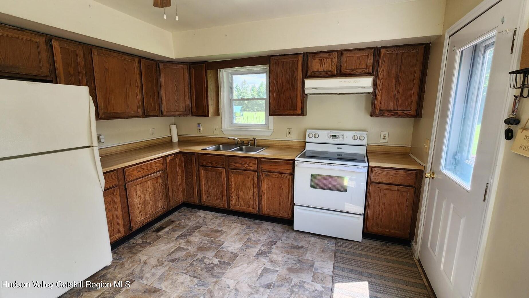 1262 County Road 2 Olivebridge, NY 12461 - Photo 16 of 42 a kitchen with a sink stove and refrigerator