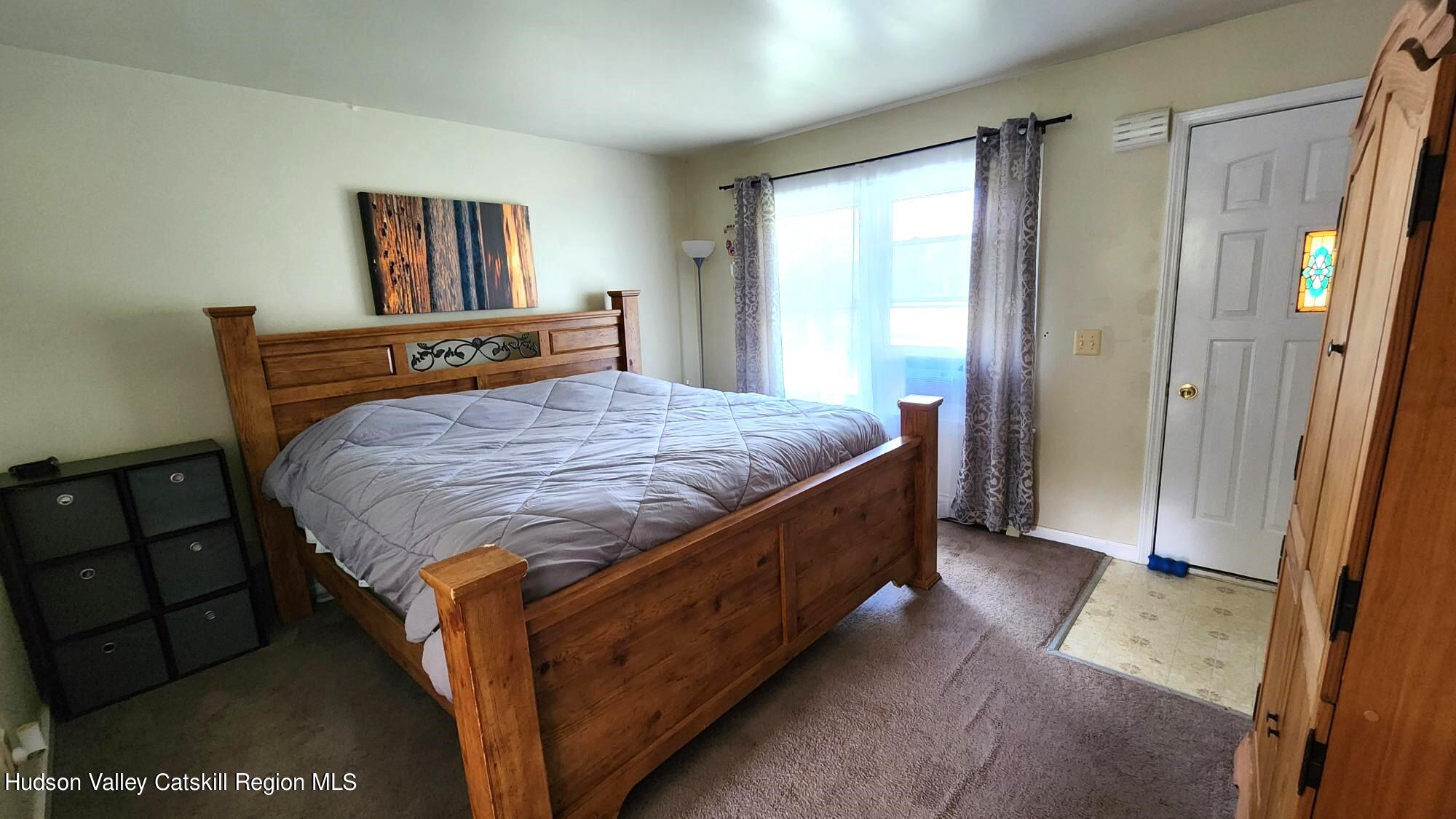 1262 County Road 2 Olivebridge, NY 12461 - Photo 18 of 42 a bed sitting in a bedroom next to a window