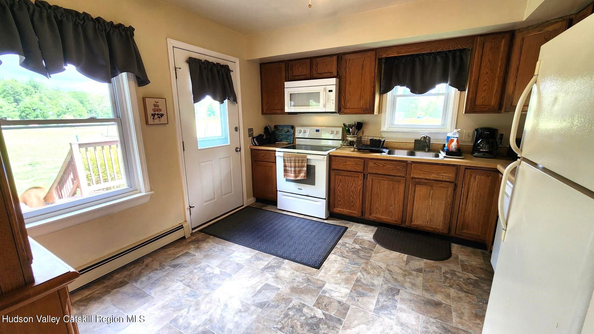 1262 County Road 2 Olivebridge, NY 12461 - Photo 8 of 42 a kitchen with stainless steel appliances granite countertop a refrigerator a stove a sink and a window