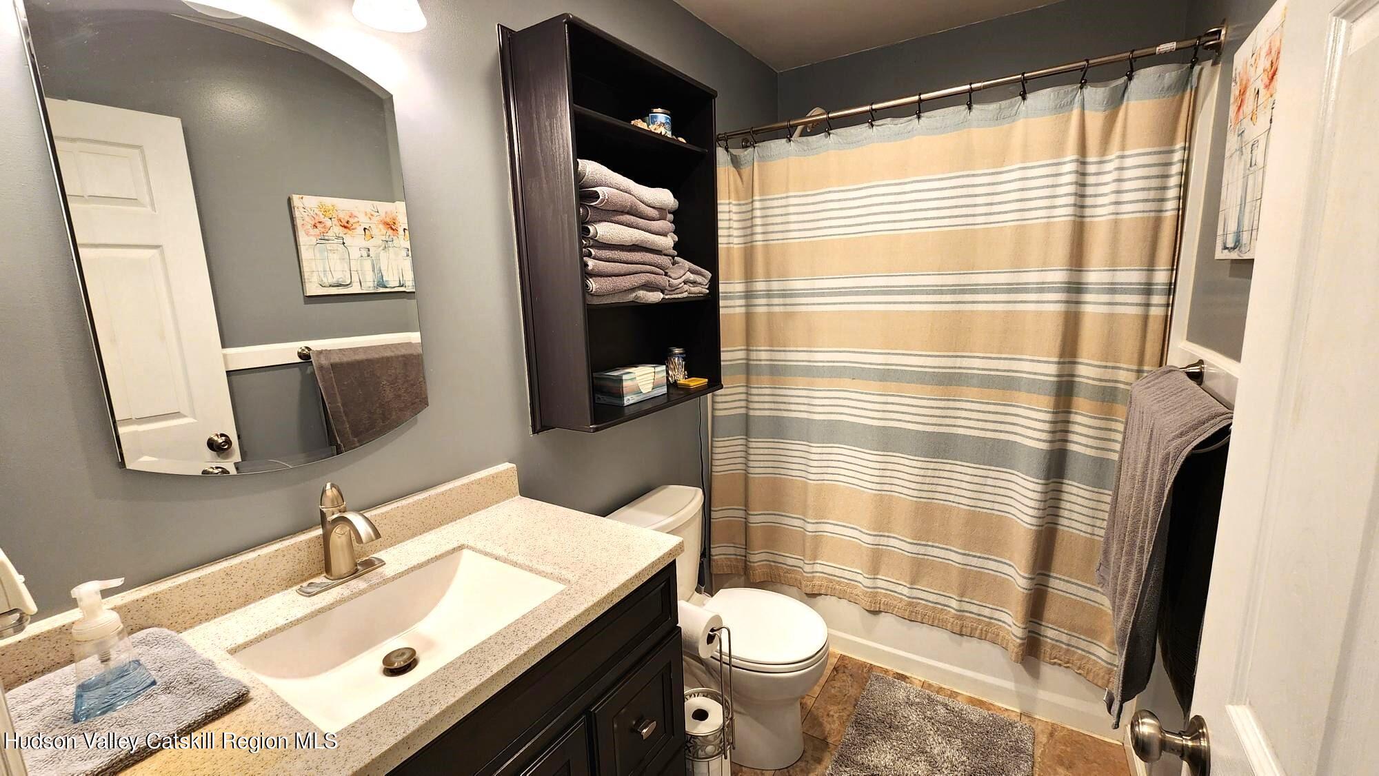 1262 County Road 2 Olivebridge, NY 12461 - Photo 10 of 42 a bathroom with a sink a toilet and shower curtain