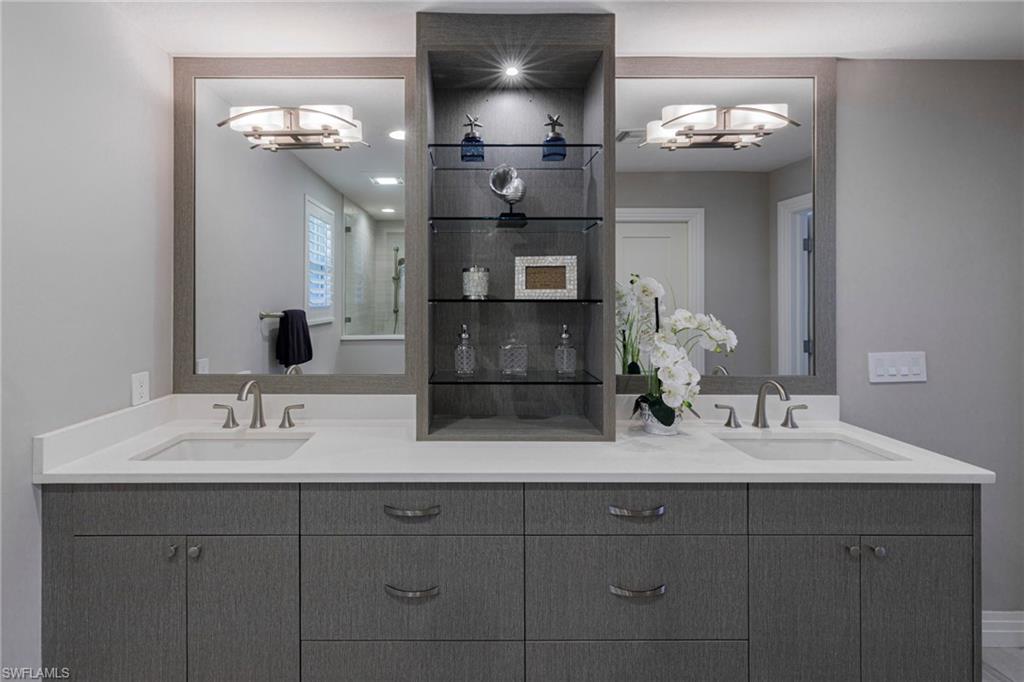 3720 Parkview Way Naples, FL 34103 - Photo 16 of 29 Bathroom featuring a notable chandelier and double vanity
