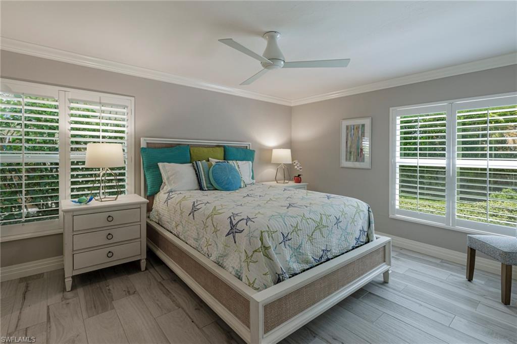 3720 Parkview Way Naples, FL 34103 - Photo 20 of 29 Bedroom featuring ceiling fan, multiple windows, and hardwood / wood-style floors