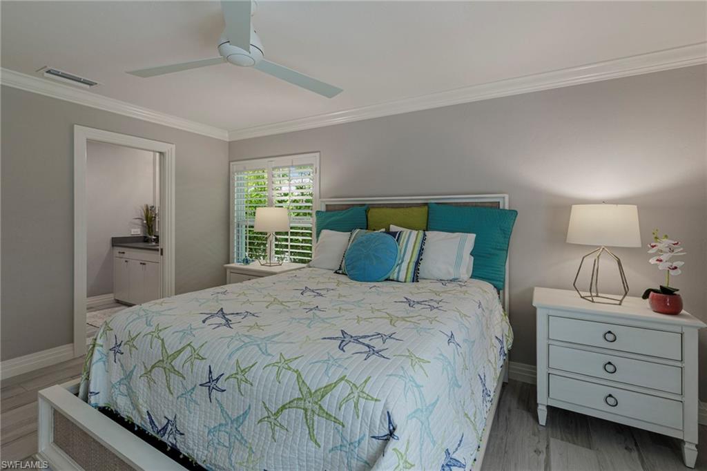 3720 Parkview Way Naples, FL 34103 - Photo 21 of 29 Bedroom with ceiling fan, ornamental molding, connected bathroom, and hardwood / wood-style flooring