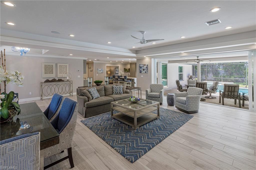 3720 Parkview Way Naples, FL 34103 - Photo 4 of 29 Living room with ceiling fan, light hardwood / wood-style flooring, and crown molding