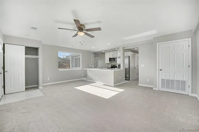 a view of empty room with wooden floor and window