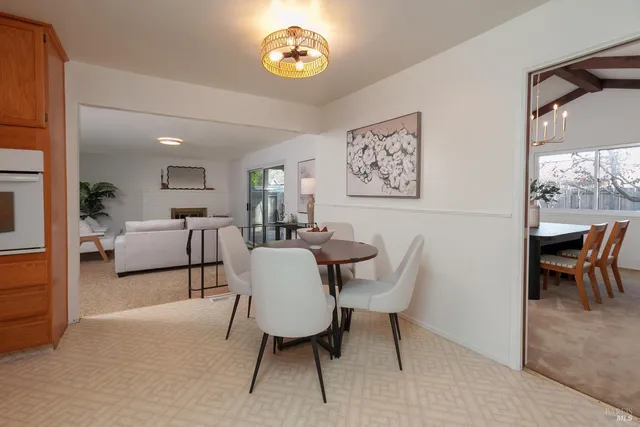 a view of a dining room with furniture and a potted plant