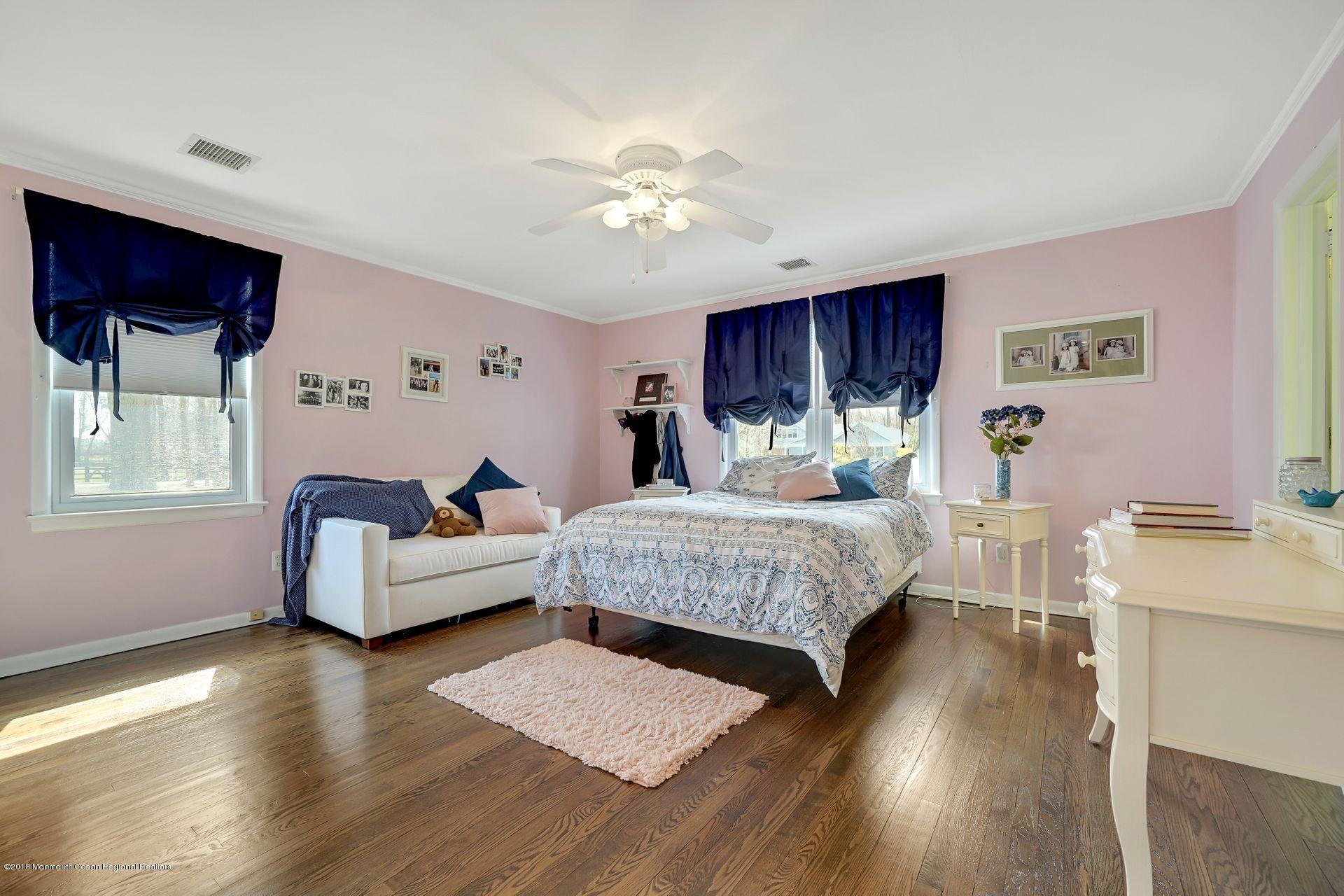 11 Heathcliff Road Rumson, NJ 07760 - Photo 20 of 31 a bedroom with a bed and a chandelier