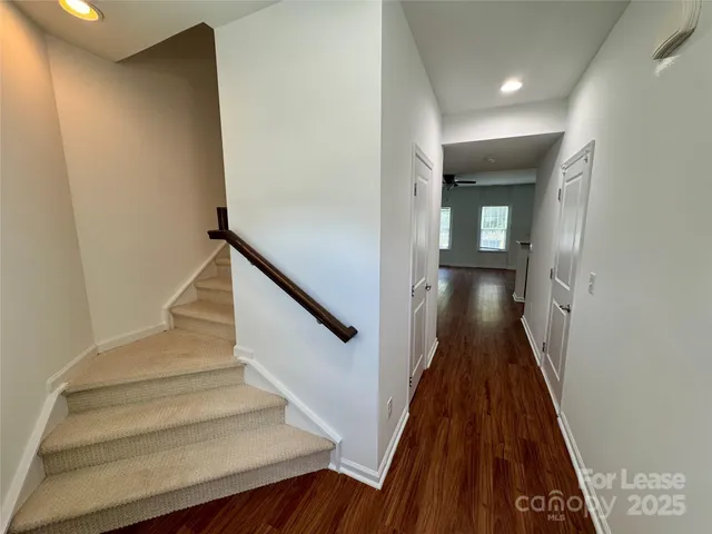 a view of entryway and hall with wooden floor