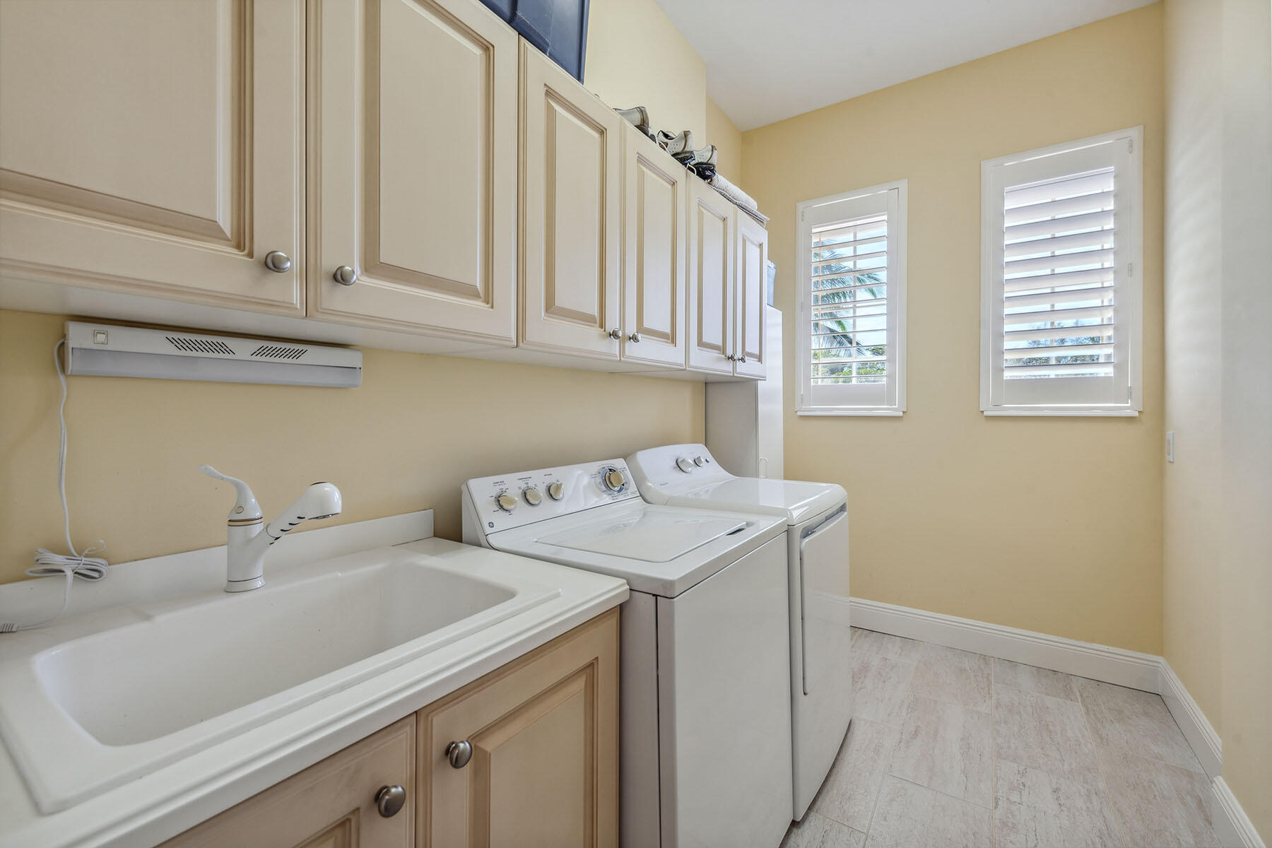 3189 Aviamar Circle, Unit 202 Naples, FL 34114 - Photo 23 of 50 a utility room with dryer and washer