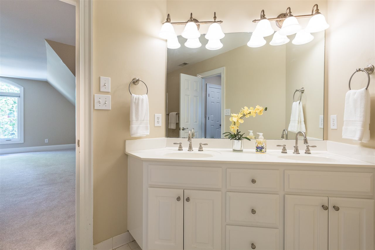 1001 Clingmans Place Raleigh, NC 27614 - Photo 20 of 30 The second floor full bath offers direct access to Bedroom 2 and Bedroom 3 and features double sinks and a tub/shower combination with tile surround. Second Floor Full Bath