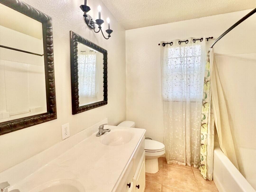 6805 36th Street Lubbock, TX 79407 - Photo 10 of 12 a bathroom with a granite countertop sink toilet and shower