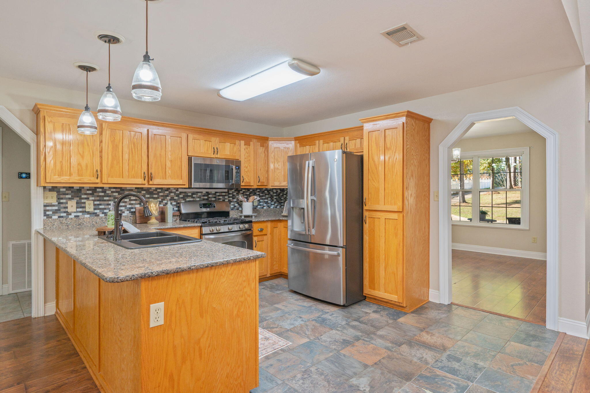 516 Blue Pond Circle Ponce de Leon, FL 32455 - Photo 13 of 39 a kitchen with refrigerator cabinets and outdoor