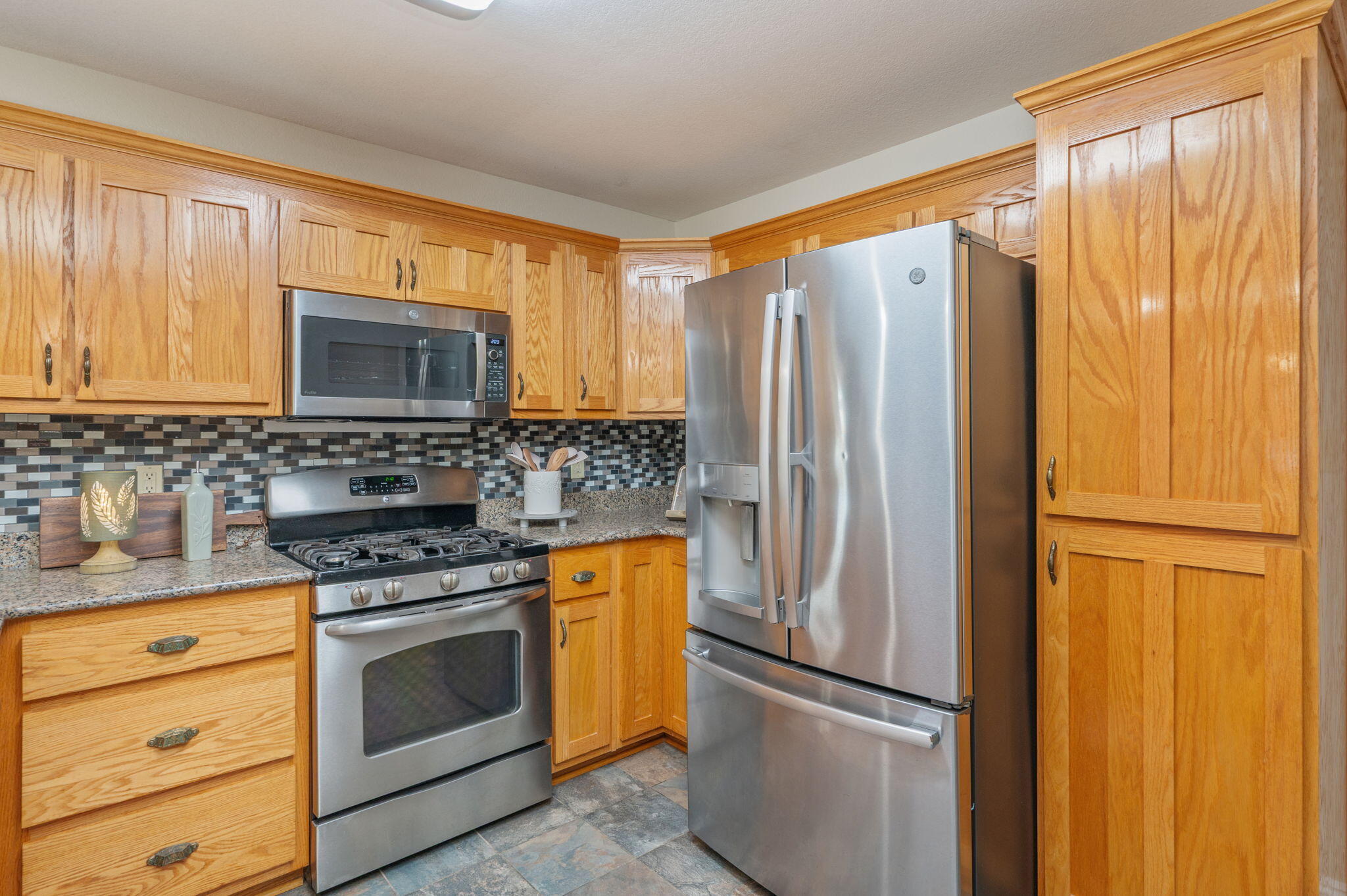 516 Blue Pond Circle Ponce de Leon, FL 32455 - Photo 15 of 39 a kitchen with appliances a refrigerator and cabinets