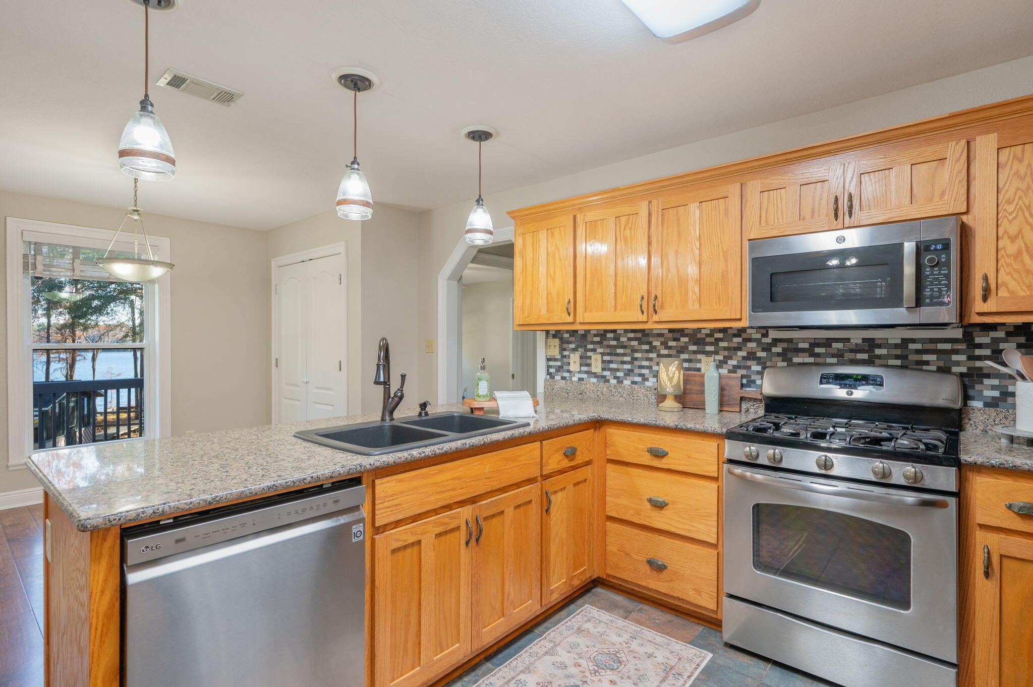 516 Blue Pond Circle Ponce de Leon, FL 32455 - Photo 16 of 39 a kitchen with granite countertop a sink stainless steel appliances and cabinets