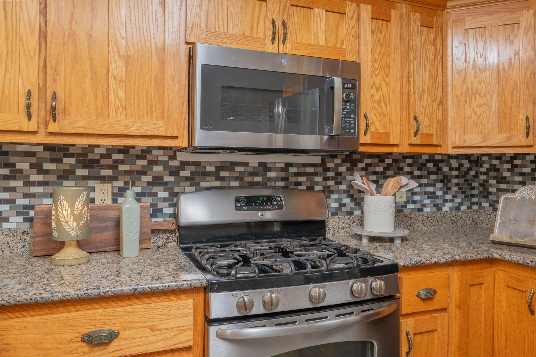 516 Blue Pond Circle Ponce de Leon, FL 32455 - Photo 18 of 39 a kitchen with granite countertop a stove top oven microwave and cabinets