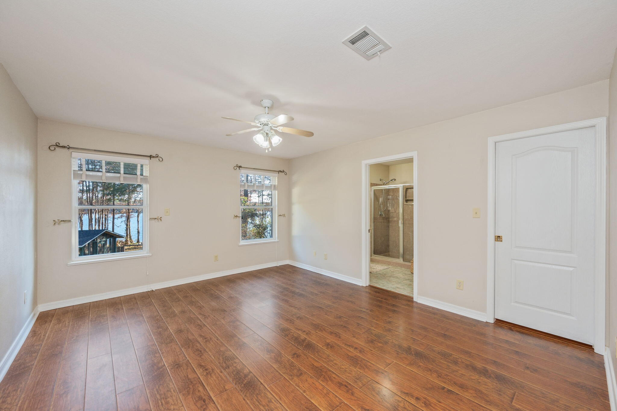 516 Blue Pond Circle Ponce de Leon, FL 32455 - Photo 19 of 39 a view of an empty room with wooden floor and a window