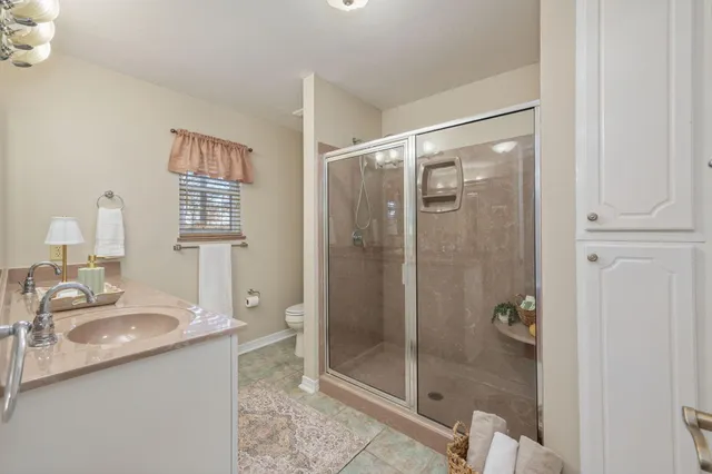 a bathroom with a shower sink and mirror