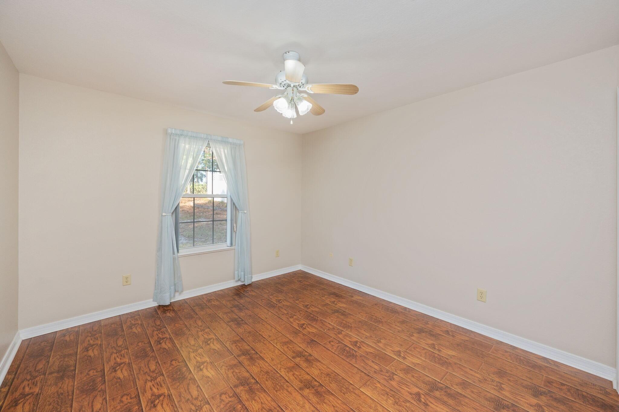516 Blue Pond Circle Ponce de Leon, FL 32455 - Photo 23 of 39 wooden floor in an empty room with a window