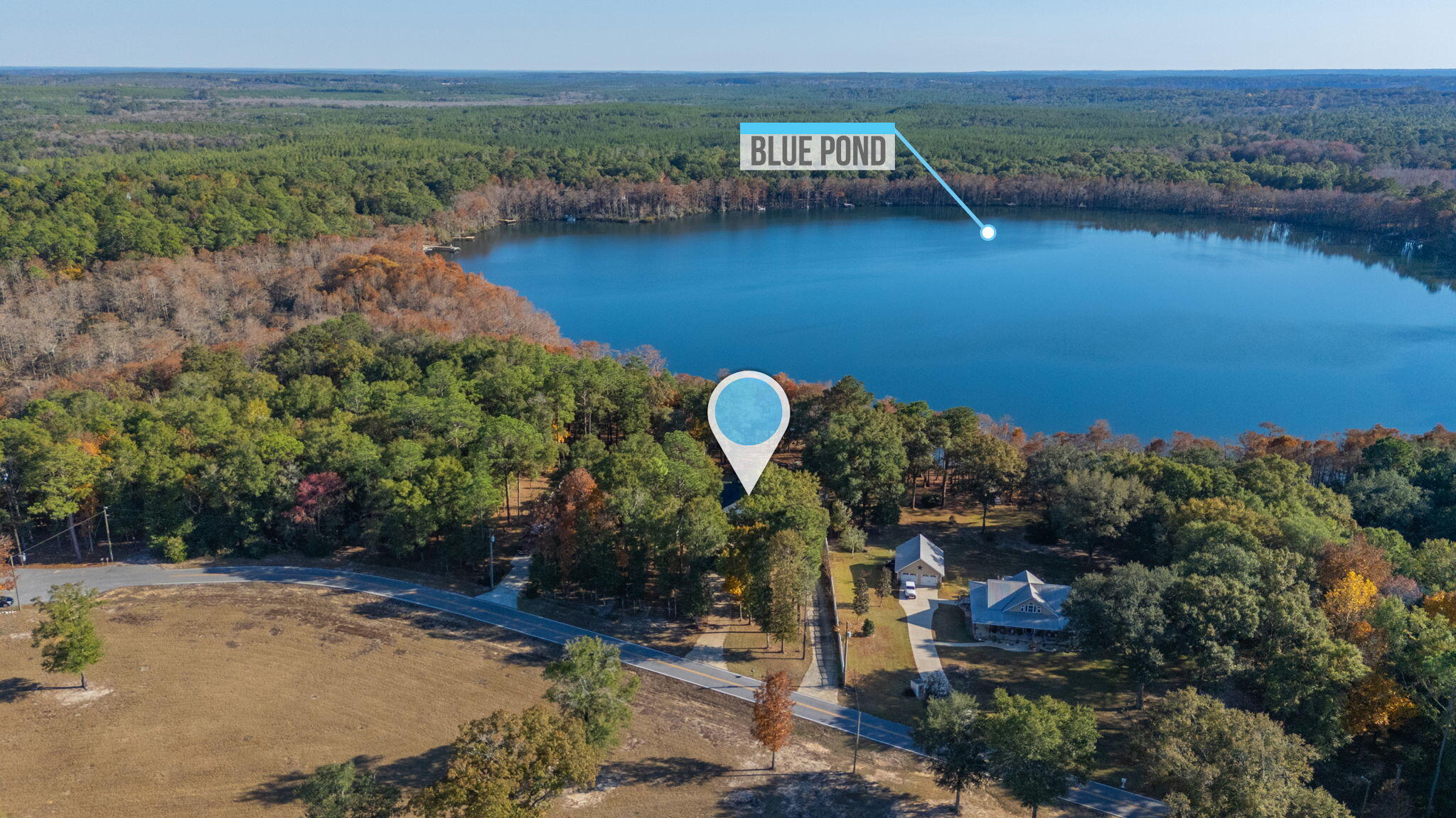 516 Blue Pond Circle Ponce de Leon, FL 32455 - Photo 36 of 39 a view of a lake with a mountain in the background