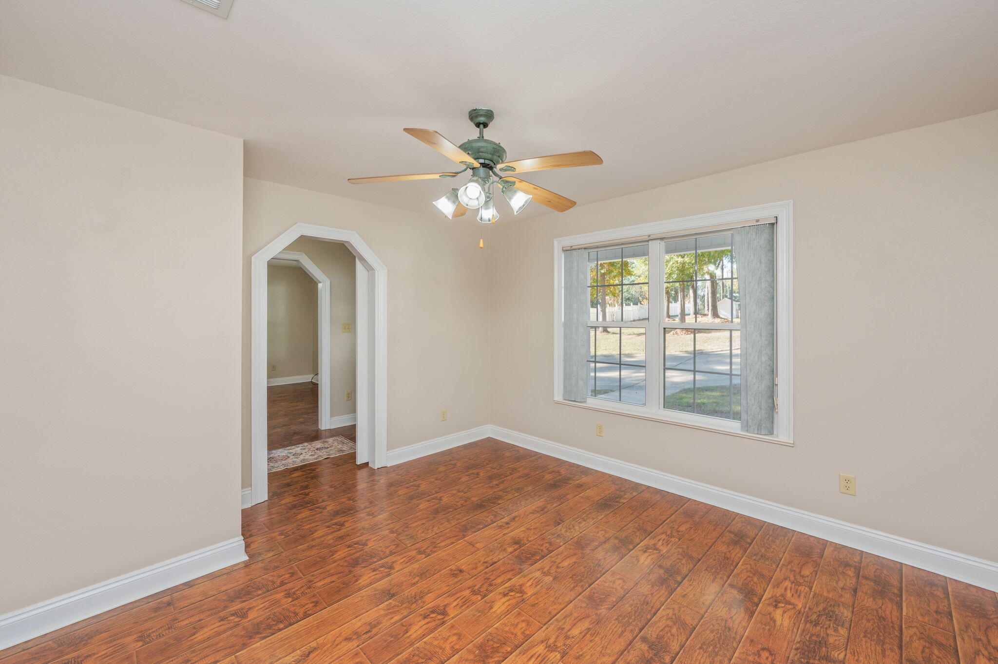 516 Blue Pond Circle Ponce de Leon, FL 32455 - Photo 9 of 39 an empty room with fan and windows