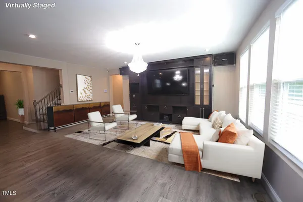 a living room with fireplace furniture and a wooden floor