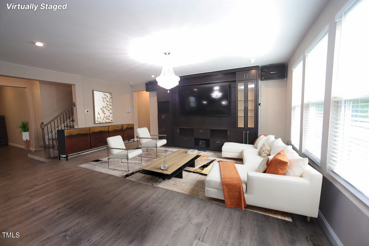 4416 Walker Hallow Street Raleigh, NC 27616 - Photo 4 of 28 a living room with fireplace furniture and a wooden floor