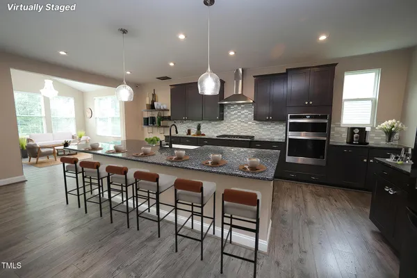 a large kitchen with a table and chairs