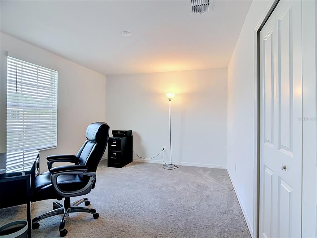 1633 Red Loop Lakeland, FL 33801 - Photo 37 of 60 a view of a workspace with furniture and a window