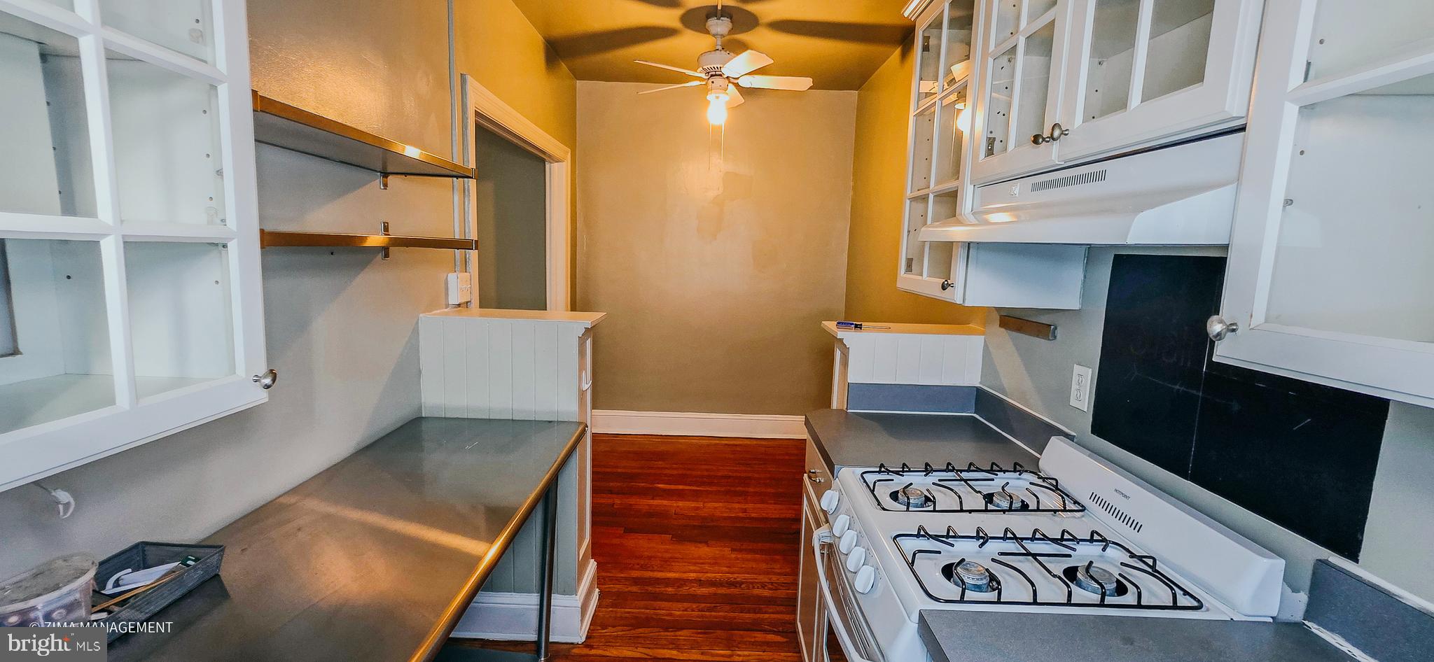 1954 Columbia Road Northwest, Unit 104 Washington, DC 20009 - Photo 17 of 17 a view of a hallway with wooden floor and staircase
