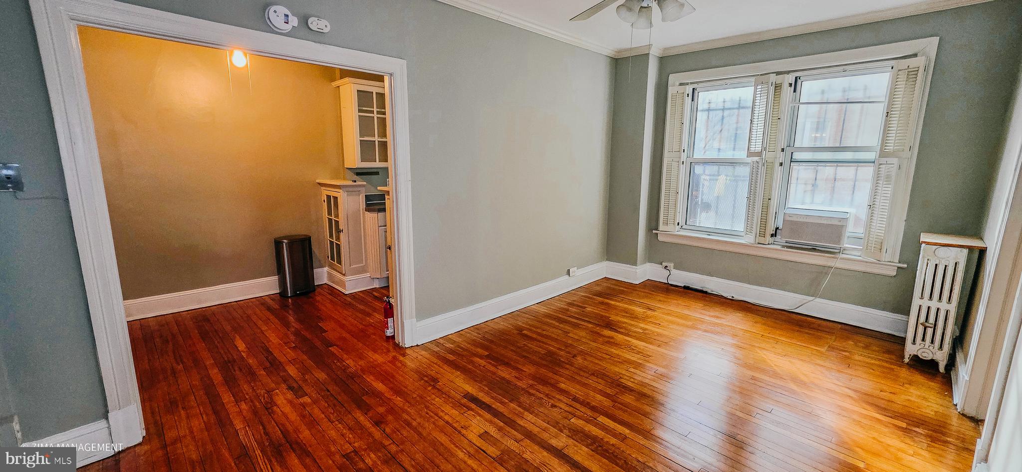1954 Columbia Road Northwest, Unit 104 Washington, DC 20009 - Photo 7 of 17 an empty room with wooden floor and a window