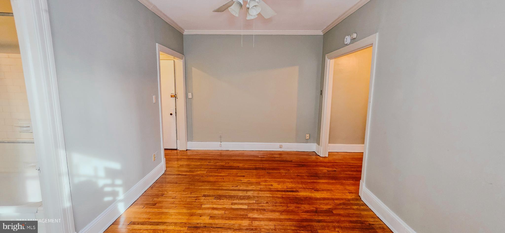 1954 Columbia Road Northwest, Unit 104 Washington, DC 20009 - Photo 8 of 17 a view of a room with wooden floor and a ceiling fan