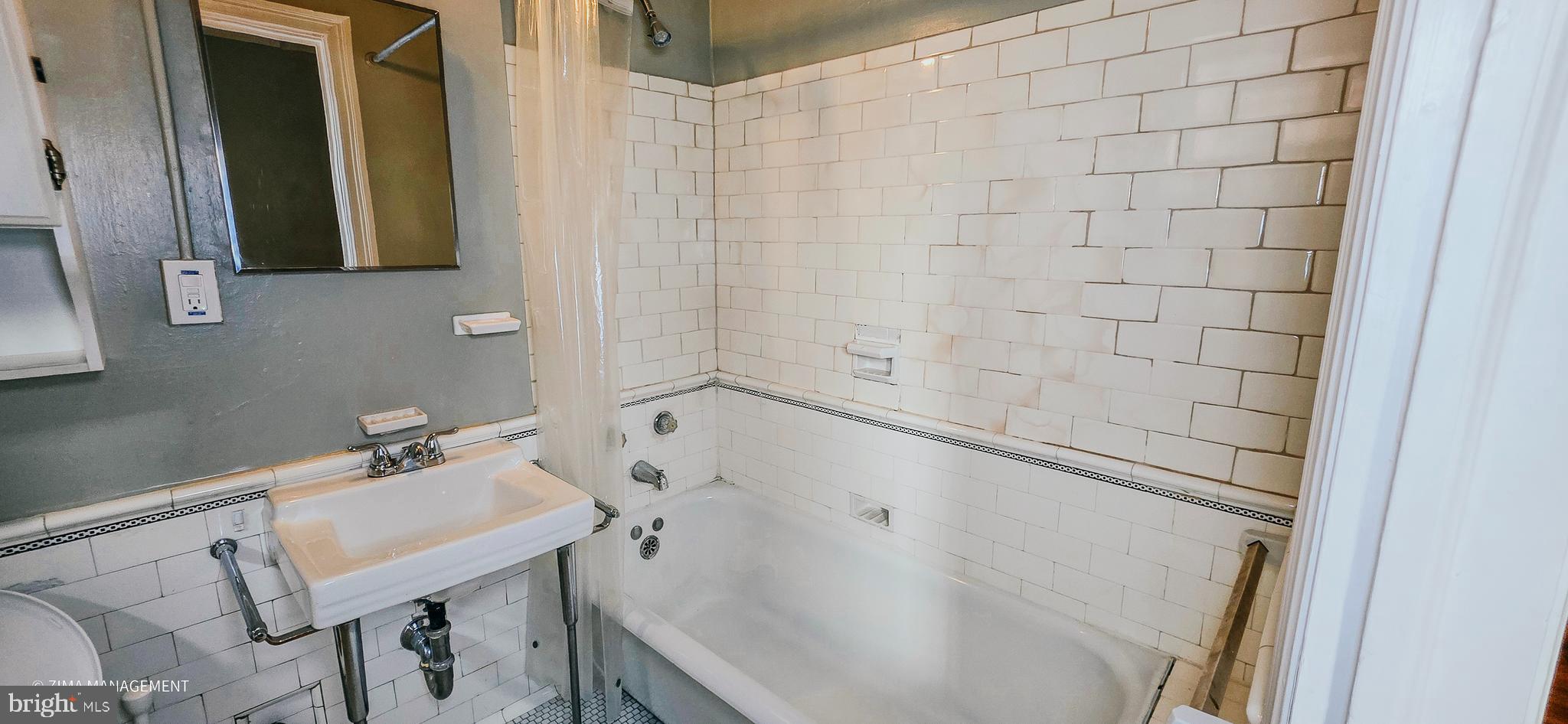 1954 Columbia Road Northwest, Unit 104 Washington, DC 20009 - Photo 9 of 17 a bathroom with a sink and a mirror