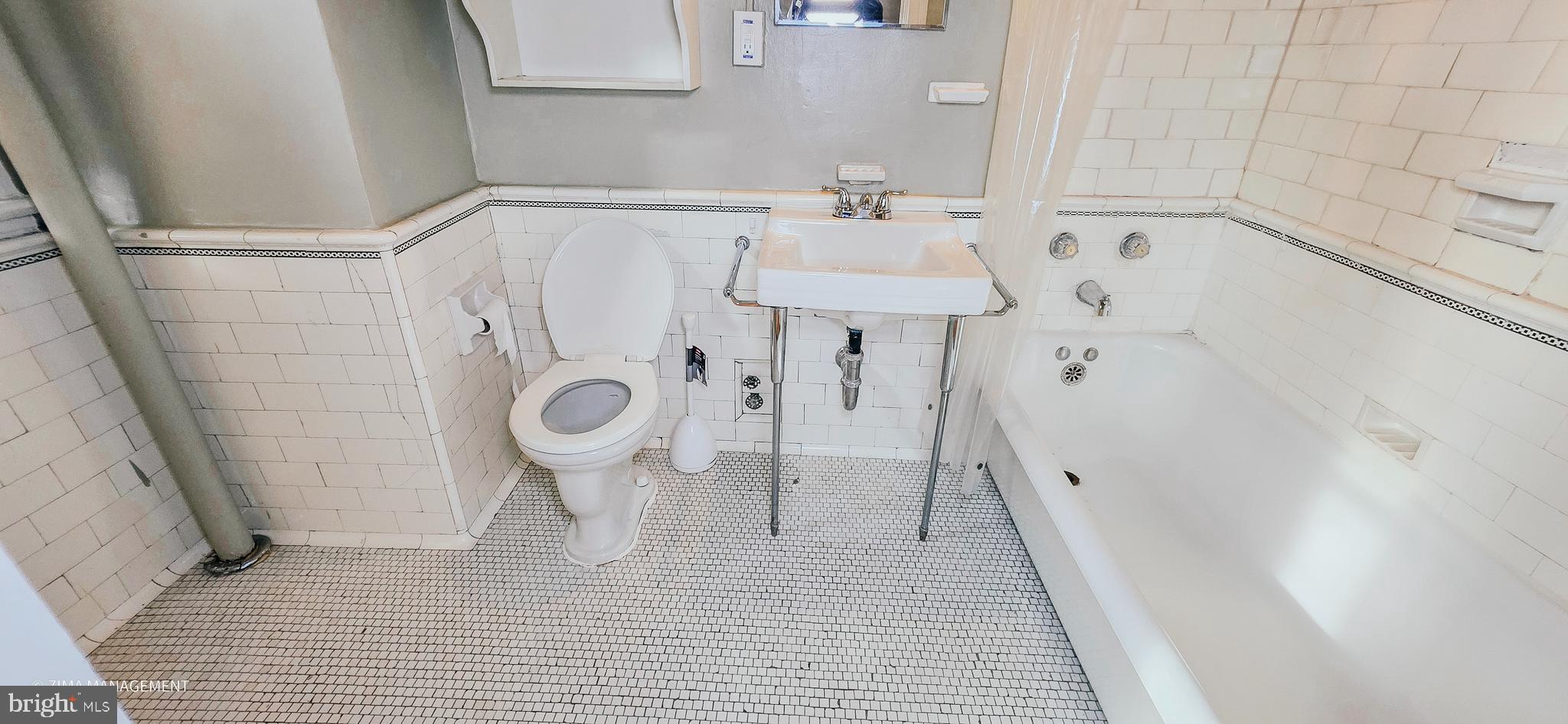 1954 Columbia Road Northwest, Unit 104 Washington, DC 20009 - Photo 10 of 17 a bathroom with a sink a toilet and shower