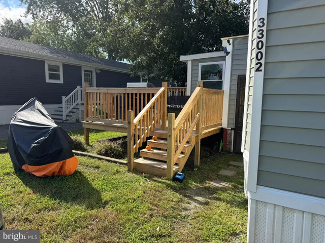 a view of a deck with chairs and a yard