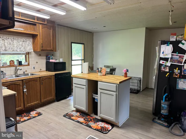 a kitchen with a sink cabinets and appliances