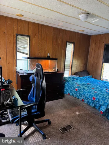 a bedroom with furniture and window