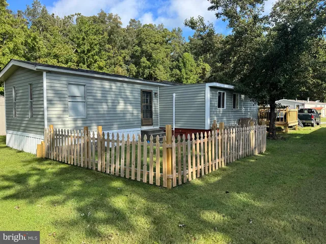 a side view of a house with a yard