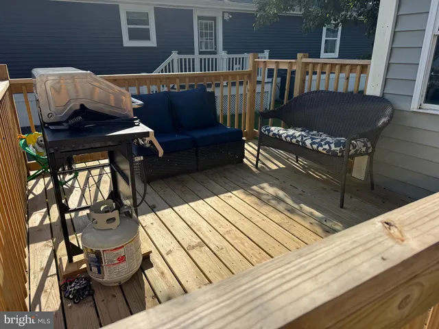 a view of a roof deck with wooden floor and outdoor seating