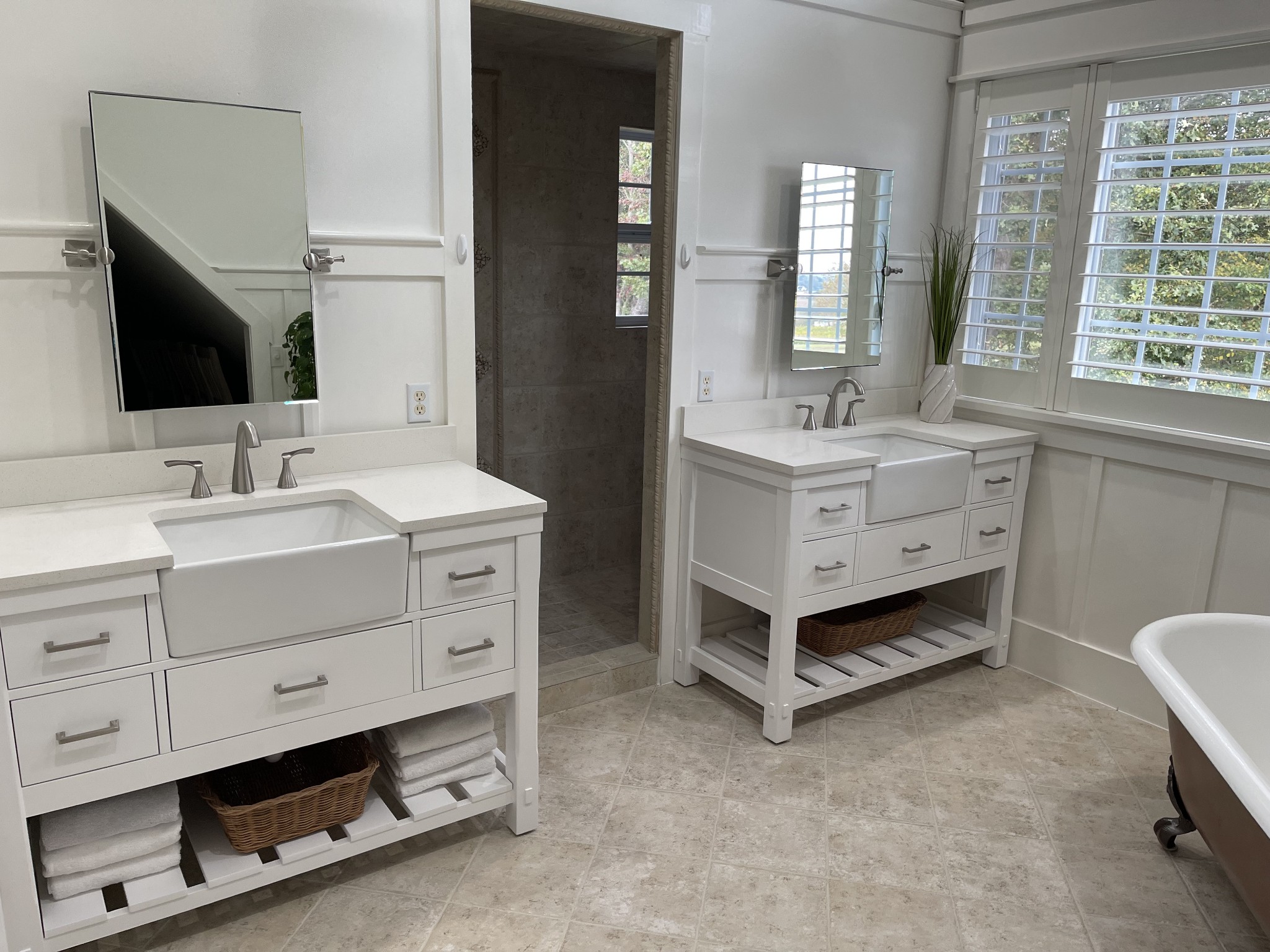 1895 Zeb Warren Road Cookeville, TN 38506 - Photo 49 of 70 a spacious bathroom with double sink a large mirror and a bathtub next to a window