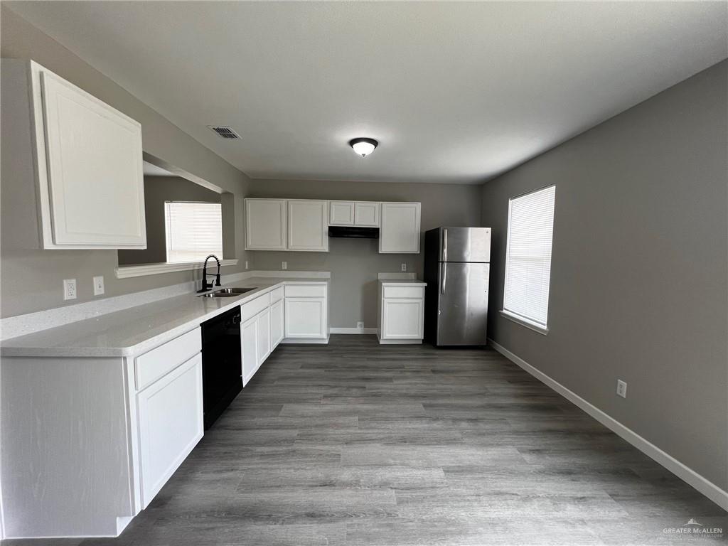 2912 Ozark Avenue McAllen, TX 78504 - Photo 4 of 21 a large kitchen with stainless steel appliances granite countertop a stove a sink dishwasher and a refrigerator