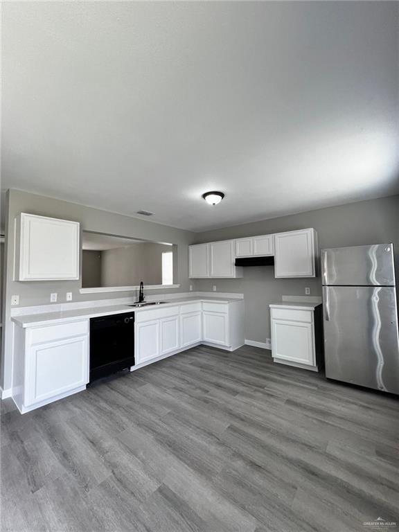 2912 Ozark Avenue McAllen, TX 78504 - Photo 5 of 21 a large kitchen with stainless steel appliances granite countertop a stove a sink dishwasher and a refrigerator with wooden floor