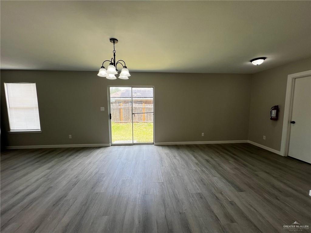 2912 Ozark Avenue McAllen, TX 78504 - Photo 7 of 21 wooden floor in an empty room with a window